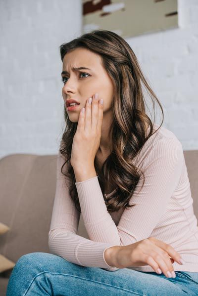 woman needing emergency dentistry in Longview, TX